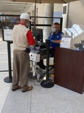 A TSA officer checks a traveler’s ID with the credential authentication technology unit at Dayton International Airport