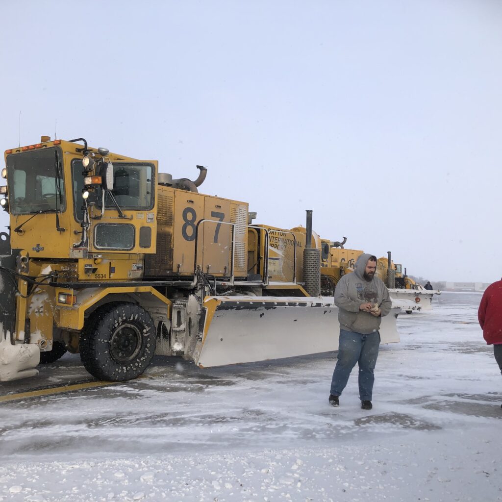 Man with snow plow at airport