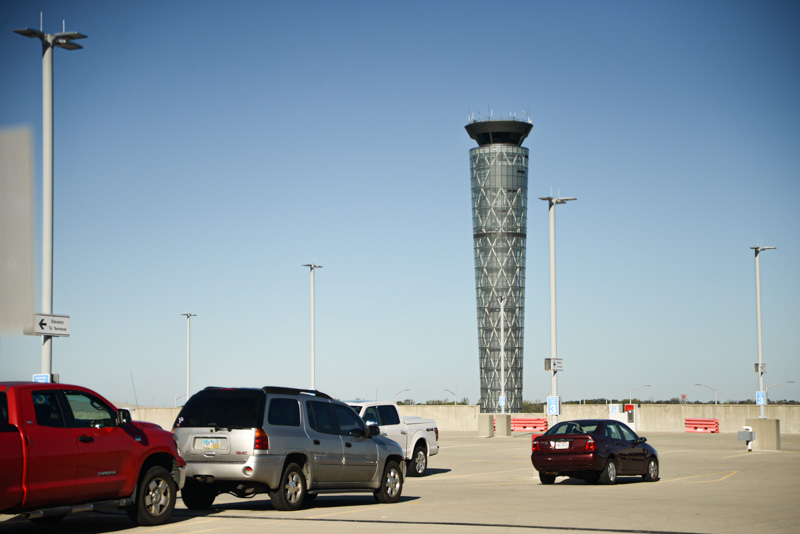 parking lot with control tower in the background